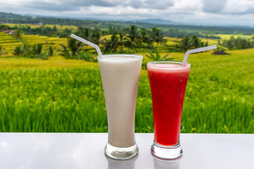 Cold and fresh Watermelon and milkshake smoothies on the rice terraces field background