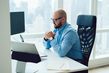 Concentrated adult man watching laptop