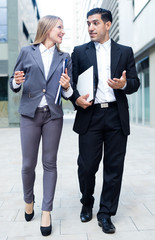 Portrait of couple who are going with folder and talking about contract