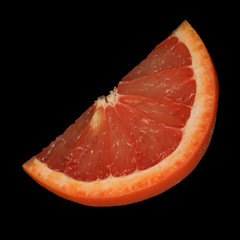 fresh red slice of grapefruit isolated on black background