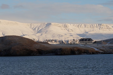 house in front of white mountain