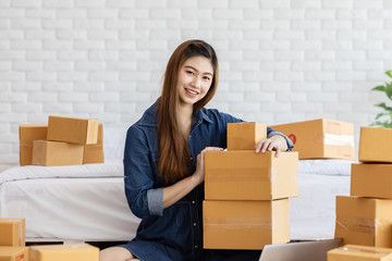 SME entrepreneur of Young Asian women working with laptop for Online shopping at home,Cheerful and Happy with box for packaging in home,Own Business Start up for Business Online and Online shopping
