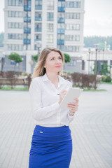 realtor girl with a notebook in her hands inspects modern residential area