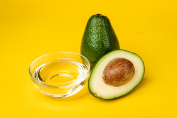Avocado oil on yellow background.