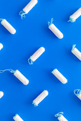 Menstrual period concept with tampons on blue background top view pattern