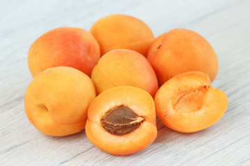 Fresh ripe orange apricot fruits on table