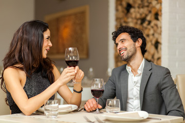 Couple toasting wineglasses in a luxury restaurant