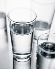 Background image of selective focus water glasses with pure clean water