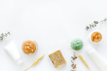 Cosmetics with natural herbal and wheat ingredients on white background top view copyspace