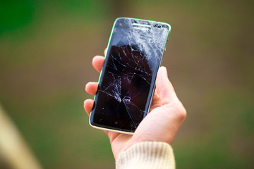 young man hold broken smartphone screen. Broken phone in hand