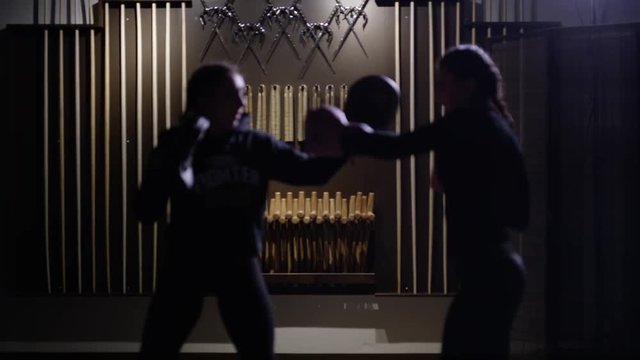 Female fighters training in dojo