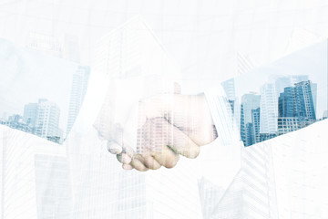 Business partnership handshake concept.Businessmans handshaking with double exposure