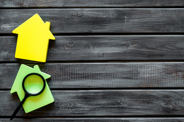 Search for a new house concept with house figure and magnifier on wooden office desk background top...