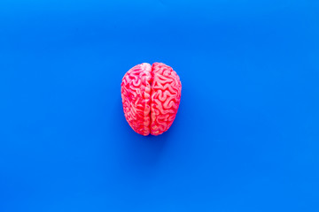 Disease of the brain concept with brain on blue background top view