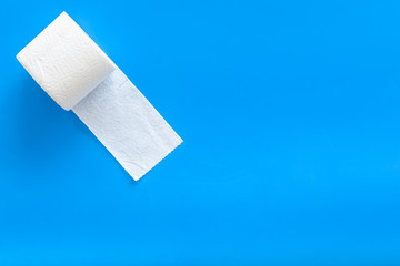 Toilet paper roll on blue background top view space for text