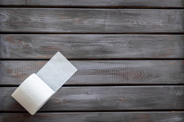 Toilet paper roll on wooden background top view mockup
