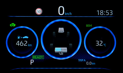 Illuminated car dashboard in hybrid car. Close up shot of display indicating battery charge level, speedometer, odometer, fuel range and outside temperature indicator which shows 32 degrees Celsius.