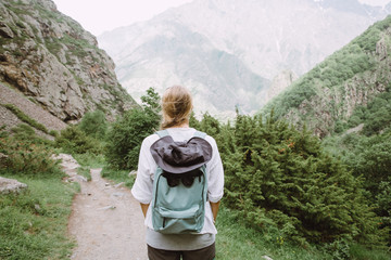 Naklejka premium Young lady tourist hiking in the mountains of Georgia