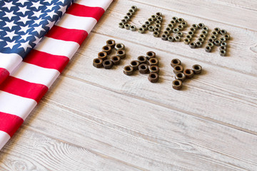 Labor day. American flag and Inscription labor day on a light wooden background.