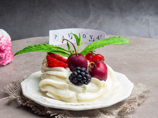 Pavlova cake with whipped cream and strawberry purple marshmallow, merengues, copy space, with inscription