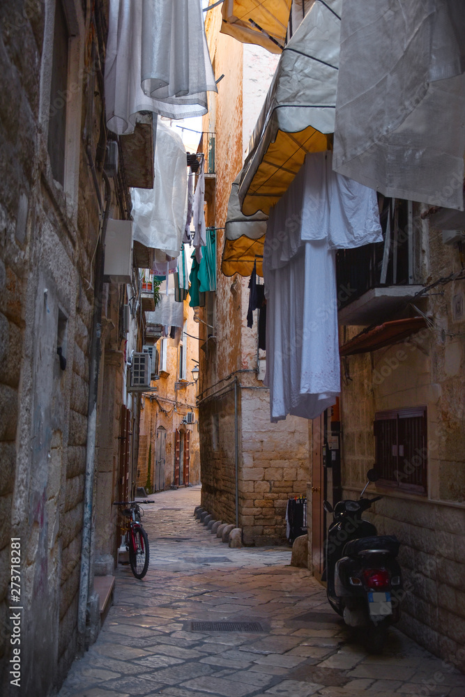 Wall mural Amazing picturesque narrow street in the Old Town of Bari, Puglia region, Southern Italy.