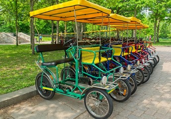 Fototapeta na wymiar Rental four wheel bikes in the park