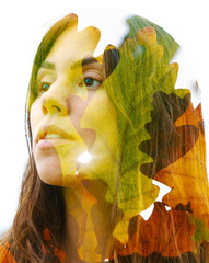 Double exposure close up of a young happy natural beauty and bright shining tropical leaves
