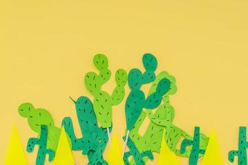 paper cactuses on yellow background