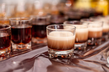 Desserts in the glasses lying on the brown table