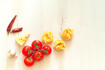 Ingredients for cooking pasta on black background. The concept of Italian cuisine.