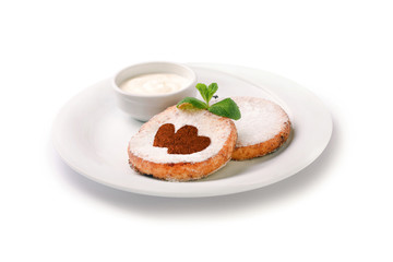 cheese pancakes on a plate with sour cream, isolated on white background
