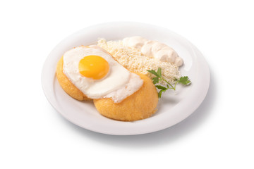 hominy with egg, cheese and cream on a plate, isolated on white background