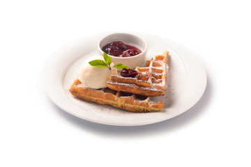 Waffle with scoop of ice cream and strawberry jam on a plate, isolated on white background