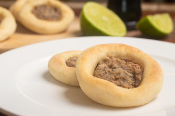 Arabic Meat sfiha over a wooden table.