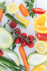 Fresh organic vegetables, cherry tomatoes, avocado, cucumbers, carrot, red and yellow pepper, green. Vegan food, healthy lifestyle concept