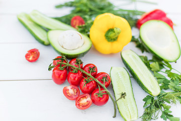 Fresh organic vegetables, cherry tomatoes, avocado, cucumbers, carrot, red and yellow pepper, green. Vegan food, healthy lifestyle concept