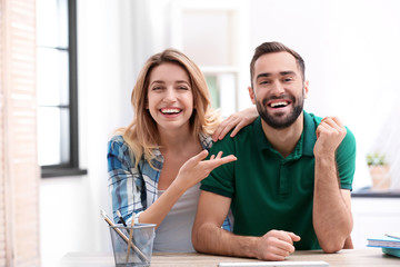 Happy couple using video chat for conversation indoors