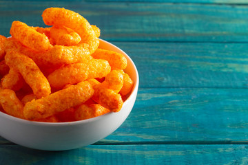 Orange Cheddar Cheese Puffs on a Wood Table