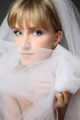 Young beautiful bride with fancy makeup and bridal veil