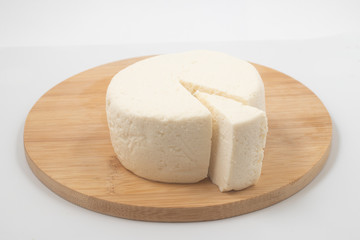 Slice of Ricotta Cheese over a wooden board