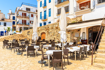 Restaurant tables in port Bo of Calella de Palafrugell, Costa Brava, Catalonia, Spain
