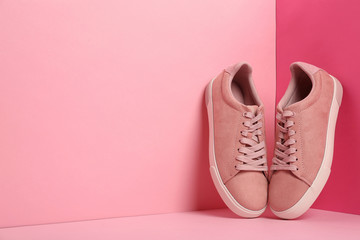 Comfortable sneakers on color background, space for text