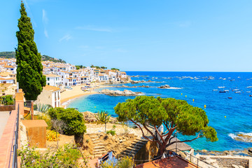 Amazing view of Calella de Palafrugell, scenic fishing village with white houses and sandy beach with clear blue water, Costa Brava, Catalonia, Spain