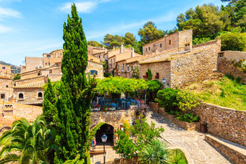 Restaurant in old town of Tossa de Mar with beautiful stone houses, Costa Brava, Spain