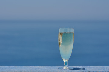 The glass of wine against the picturesque sea view illustrating the holiday and relax atmosphere.