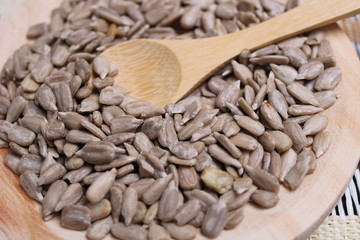 Round wooden board with sunflower seeds