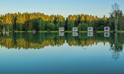 Summer evening landscape with reflection of  forest in  lake