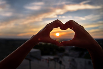 Concept or conceptual woman hands in love, symbol of heart over Montreal background. Heart shape...