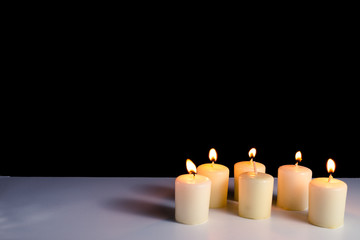 Fototapeta na wymiar Burning candles on a white background. Obon festival. Diwali festival