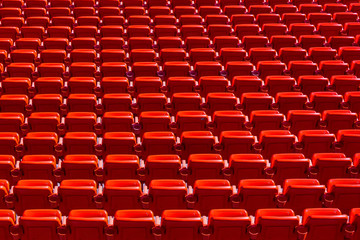 Abstract Geometric Background of Red Seats in Empty Sports Stadium